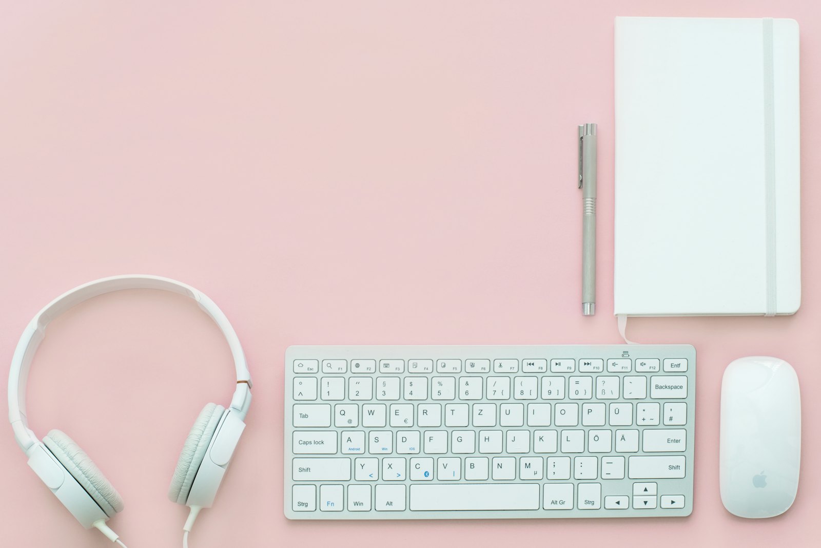 A tidy desk with keyboard, mouse and headphones