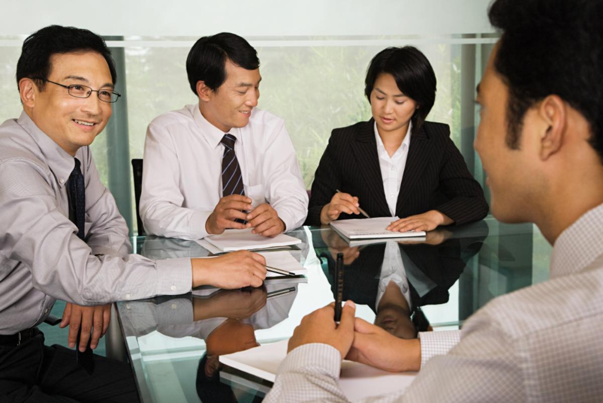 Colleagues talking around a meeting table